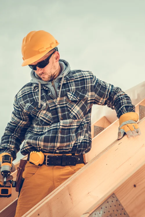 Wooden House Roof Skeleton Frame Assembly by Professional Construction Worker